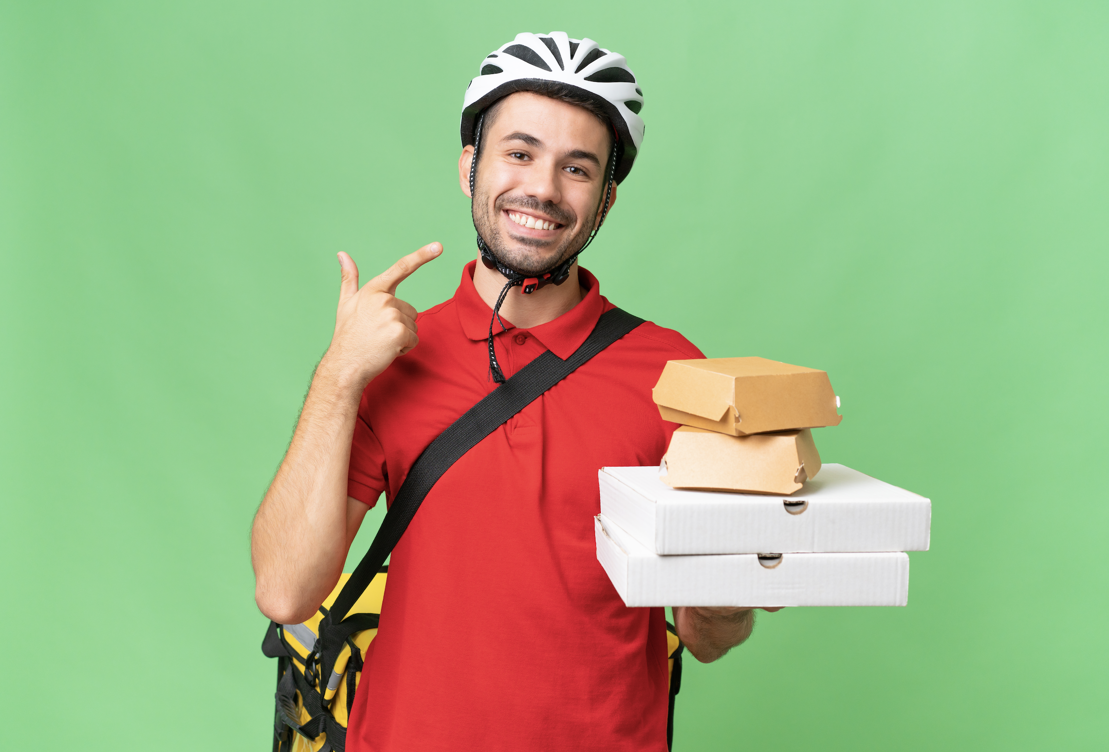 young and fit delivery driver holding delivery items